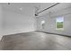 Spacious garage with concrete floor, natural lighting, and ample room for parking and storage at 6120 Hutchins Dr, Buford, GA 30518