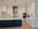 Gourmet kitchen with large island, stainless steel appliances, custom cabinets, and tile backsplash at 6120 Hutchins Dr, Buford, GA 30518