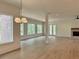 Bright and airy living room featuring hardwood floors, a fireplace, and many windows with natural light at 6120 Hutchins Dr, Buford, GA 30518
