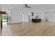 Expansive living room leading into a modern kitchen with dark island, white cabinets, and stainless appliances at 6120 Hutchins Dr, Buford, GA 30518