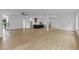 An open-concept living area featuring hardwood flooring, a modern kitchen, fireplace, and abundant natural light at 6120 Hutchins Dr, Buford, GA 30518