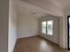 Bright room featuring hardwood floors, decorative trim, and natural light from a window at 6120 Hutchins Dr, Buford, GA 30518