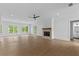 Bright and airy living room featuring hardwood floors, fireplace, large windows, and recessed lighting at 6120 Hutchins Dr, Buford, GA 30518