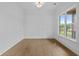Serene office featuring hardwood floors, bright windows and elegant paneled accent wall at 6120 Hutchins Dr, Buford, GA 30518