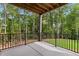 Covered patio offers scenic views of the lush green lawn and trees at 6120 Hutchins Dr, Buford, GA 30518