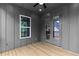 Charming covered patio with wood floors, ceiling fan and access to the yard at 6120 Hutchins Dr, Buford, GA 30518