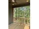 Screened-in porch with wood floors and a wooded view at 6120 Hutchins Dr, Buford, GA 30518