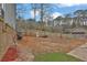 A large backyard area with a wood fence at the rear at 670 Westbrook Pl, Lawrenceville, GA 30044