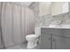 Cozy bathroom with gray vanity, white toilet, and shower with curtain at 670 Westbrook Pl, Lawrenceville, GA 30044