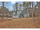 Charming light blue home features a two-car garage and a landscaped front yard at 670 Westbrook Pl, Lawrenceville, GA 30044