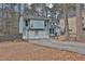 Charming light blue home features a two-car garage and basketball hoop in a wooded suburban neighborhood at 670 Westbrook Pl, Lawrenceville, GA 30044