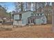 Charming light blue home features a two-car garage and a landscaped front yard at 670 Westbrook Pl, Lawrenceville, GA 30044