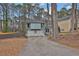 Charming light blue home features a two-car garage and basketball hoop in a wooded suburban neighborhood at 670 Westbrook Pl, Lawrenceville, GA 30044