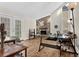 Bright living room featuring hardwood floors, a stone fireplace, and large windows at 670 Westbrook Pl, Lawrenceville, GA 30044