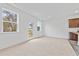 Bright living space with neutral carpet, windows and glass panel door, next to modern kitchen at 1528 Parks Edge Nw Ln, Atlanta, GA 30318