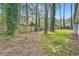 Spacious backyard with mature trees and wooden fence at 9053 Franklin Ct, Jonesboro, GA 30238