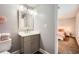 Bathroom with gray vanity, modern mirror, and view into bedroom at 9053 Franklin Ct, Jonesboro, GA 30238