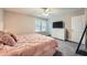 A spacious bedroom with two windows, a ceiling fan, and a large dresser at 9053 Franklin Ct, Jonesboro, GA 30238