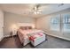 A bedroom with large windows, neutral paint, and carpet at 9053 Franklin Ct, Jonesboro, GA 30238