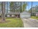 Charming single-Gathering home boasts a well-manicured front yard, driveway, and attached garage at 9053 Franklin Ct, Jonesboro, GA 30238