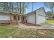 Charming single-Gathering home boasts a well-manicured front yard, driveway, and attached garage at 9053 Franklin Ct, Jonesboro, GA 30238