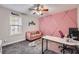 Charming home office featuring pink accent wall and modern decor at 9053 Franklin Ct, Jonesboro, GA 30238