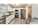 A modern kitchen featuring stainless steel appliances and white shaker style cabinets at 9053 Franklin Ct, Jonesboro, GA 30238