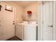 A laundry room with a washer and dryer and a door to the exterior at 9053 Franklin Ct, Jonesboro, GA 30238