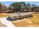 Aerial view of the home with a long driveway surrounded by trees at 96 Sam Alexander Rd, Douglasville, GA 30134
