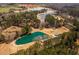 Stunning aerial view of a serene pond surrounded by lush green trees, offering a peaceful retreat at 96 Sam Alexander Rd, Douglasville, GA 30134