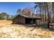 Rustic barn with gated paddock set amidst mature trees, perfect for livestock or storage at 96 Sam Alexander Rd, Douglasville, GA 30134