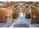 Interior view of the horse barn with wooden stalls, concrete floors, and open rafters at 96 Sam Alexander Rd, Douglasville, GA 30134