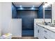 Sleek bathroom featuring a walk-in shower with black tiling and a double sink vanity with granite counters at 96 Sam Alexander Rd, Douglasville, GA 30134