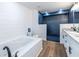 Bright bathroom with a large tub, a tiled shower, and double vanity, offering a spa-like retreat at 96 Sam Alexander Rd, Douglasville, GA 30134