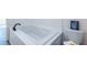 Modern bathroom featuring a sleek white jacuzzi tub and coordinating toilet at 96 Sam Alexander Rd, Douglasville, GA 30134