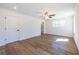 Bright and airy bedroom featuring hardwood floors and ceiling fan, lit by natural light through large windows at 96 Sam Alexander Rd, Douglasville, GA 30134