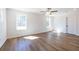 Well-lit bedroom featuring neutral walls, hardwood floors, and windows showcasing a wooded view at 96 Sam Alexander Rd, Douglasville, GA 30134