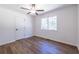 Bright bedroom showcasing wood floors, a ceiling fan, and a window for ample natural light at 96 Sam Alexander Rd, Douglasville, GA 30134