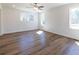 Spacious bedroom with hardwood floors, a ceiling fan, and natural light from large windows at 96 Sam Alexander Rd, Douglasville, GA 30134