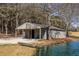 Exterior view of the barn near the pond and boat at 96 Sam Alexander Rd, Douglasville, GA 30134