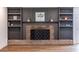 Brick fireplace with built-in shelving and decorative accents, offering a cozy focal point at 96 Sam Alexander Rd, Douglasville, GA 30134