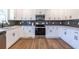 Modern kitchen with white cabinets, stainless steel appliances, and a gray tile backsplash at 96 Sam Alexander Rd, Douglasville, GA 30134