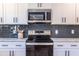 New kitchen featuring stainless steel microwave and range, complemented by granite countertops at 96 Sam Alexander Rd, Douglasville, GA 30134