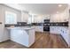 Well-lit kitchen featuring white cabinetry, gray subway tile, and modern appliances at 96 Sam Alexander Rd, Douglasville, GA 30134