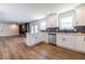 Bright, updated kitchen with white cabinets, stainless steel appliances, and open access to the living area at 96 Sam Alexander Rd, Douglasville, GA 30134