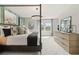 Spacious bedroom featuring a four-poster bed, modern lighting, and a serene window view at 300 Shine Dr, Stockbridge, GA 30281