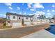 New townhouses with white siding, brick facade, attached single-car garages, and landscaped front yards at 300 Shine Dr, Stockbridge, GA 30281