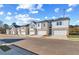New townhouses with white siding, brick facade, attached single-car garages, and landscaped front yards at 300 Shine Dr, Stockbridge, GA 30281