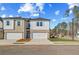 New two-story townhouse with white siding, brick facade, and attached single-car garage at 300 Shine Dr, Stockbridge, GA 30281