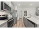 Modern kitchen boasts stainless steel appliances, granite countertops, and ample cabinet space at 300 Shine Dr, Stockbridge, GA 30281